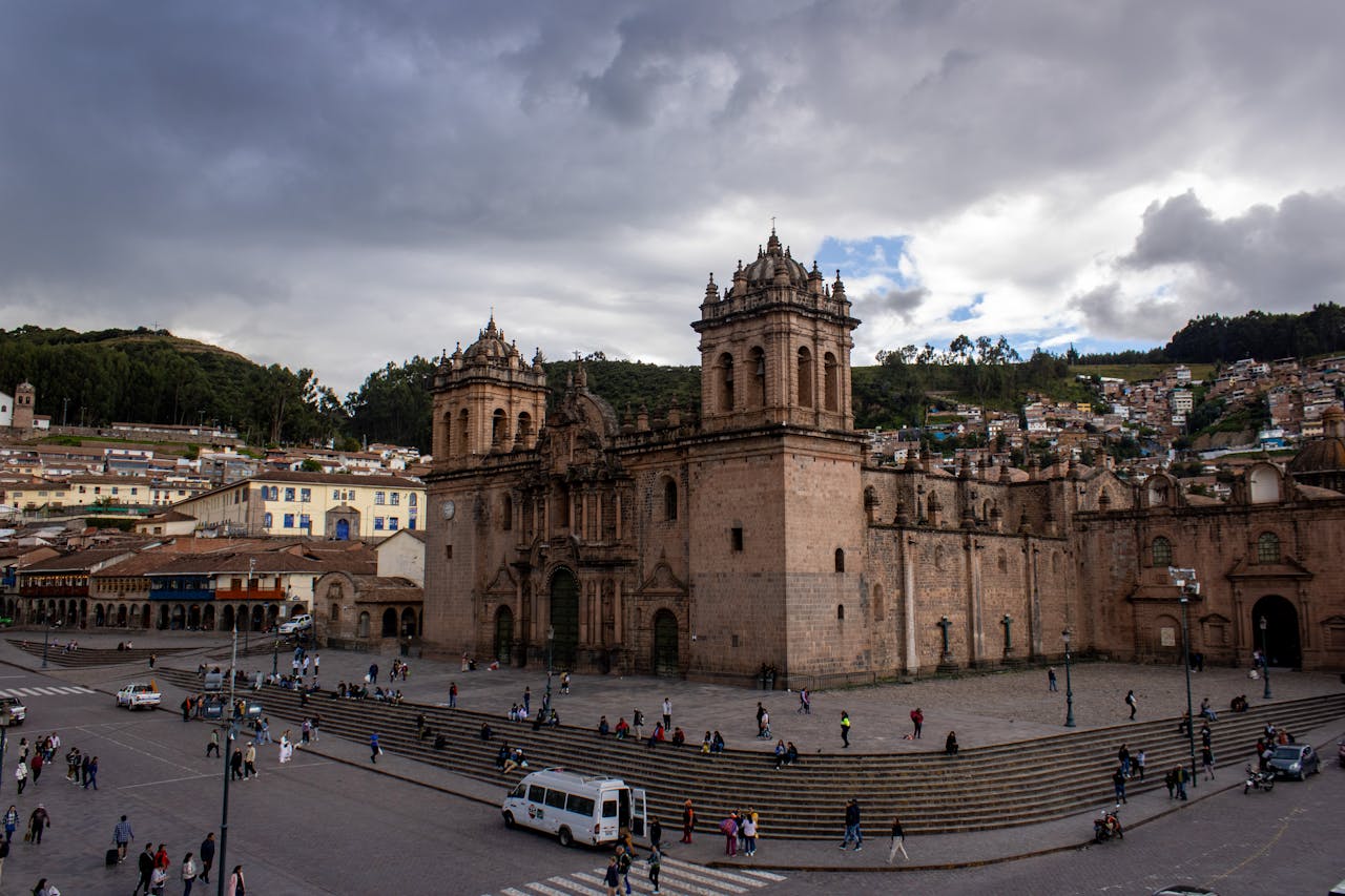 Panoramic view of Cusco Cathedral and Plaza de Armas with dramatic Andean sky (best time to visit cusco) | Cusco Tours
